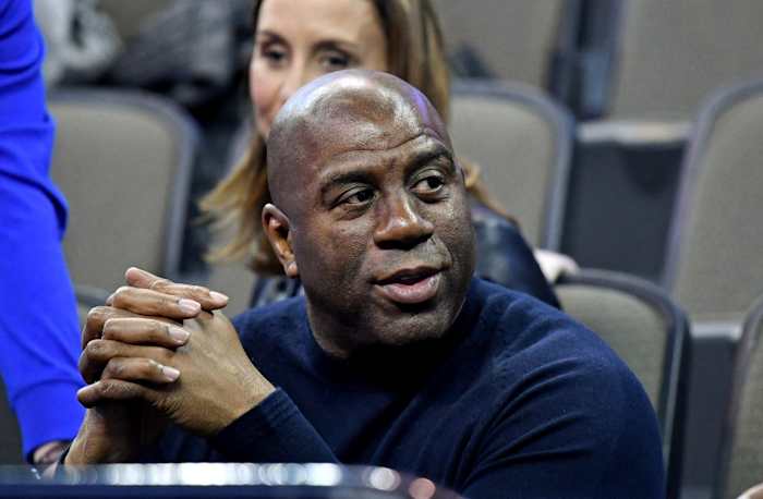 NBA former player Magic Johnson watches during the first half between the Clemson Tigers and the Kansas Jayhawks in the semifinals of the Midwest regional of the 2018 NCAA Tournament at CenturyLink Center.